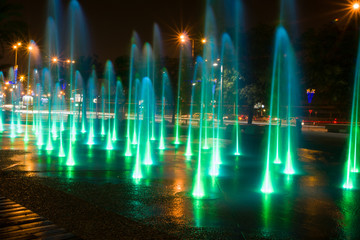 Fountain colored water show. Colorful fontain light in city