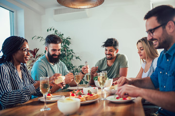 Group of multiethnic friends enjoying dinner party