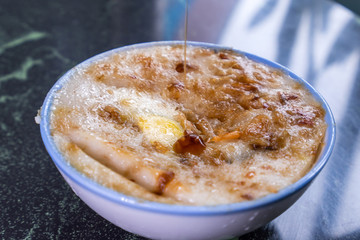 Taiwan's distinctive famous snacks: Savory rice pudding (Wa gui) in a white bowl on stone table, Taiwan Delicacies, Taiwan Street Food