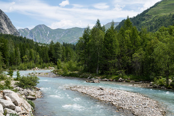 The Dora River runs through Val Ferret in the Italian Alps near Courmayeur on a beautiful summer day