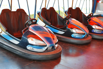 Electric bumper cars in autodrom in fairground attractions at amusement park.