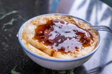 Taiwan's distinctive famous snacks: Savory rice pudding (Wa gui) in a white bowl on stone table, Taiwan Delicacies, Taiwan Street Food