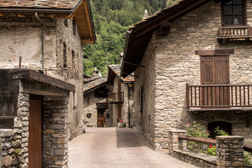 Typical stone house buildings in an italian alpine village near Courmayeur, The Alps, Italy. - obrazy, fototapety, plakaty