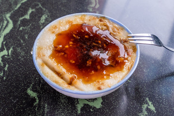Taiwan's distinctive famous snacks: Savory rice pudding (Wa gui) in a white bowl on stone table, Taiwan Delicacies, Taiwan Street Food