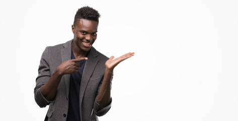 Young african american man wearing a jacket very happy pointing with hand and finger