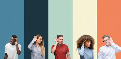 Group of people over vintage colors background smiling with hand over ear listening an hearing to rumor or gossip. Deafness concept. - obrazy, fototapety, plakaty