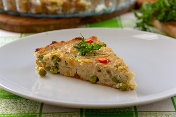 piece of vegetable pie with green peas