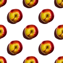 Seamless pattern of apples on green background