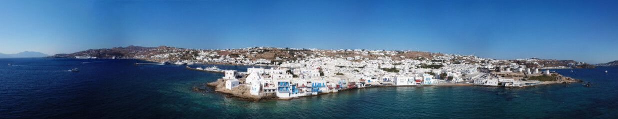 Fototapeta na wymiar Aerial ultra wide panoramic drone view of iconic chora of Mykonos island featuring picturesque little Venice, Cyclades, Aegean, Greece