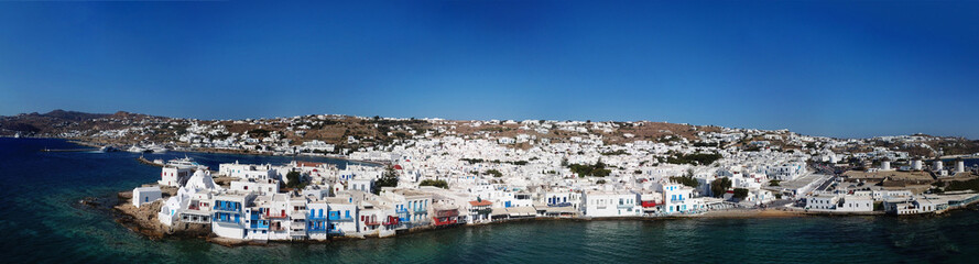 Fototapeta na wymiar Aerial ultra wide panoramic drone view of iconic chora of Mykonos island featuring picturesque little Venice, Cyclades, Aegean, Greece