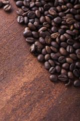 Photo closeup of coffee beans. Rusty background. Copy space.
