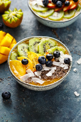 Healthy Smoothie Bowl with chia seeds, coconut flakes, kiwi and blueberries.