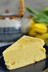 A piece of healthy cheesecake on a dark blue saucer