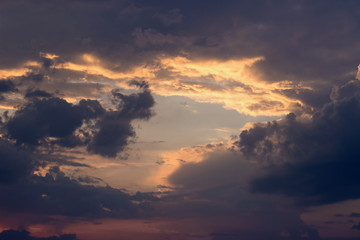 Naklejka na ściany i meble Dramatic gray clouds on the sky; rays of sunshine before the storm
