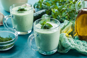 Cold cucumber soup with dill and mint served in glassful. Summer dish
