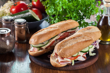 Submarine sandwiches with ham, cheese and vegetables