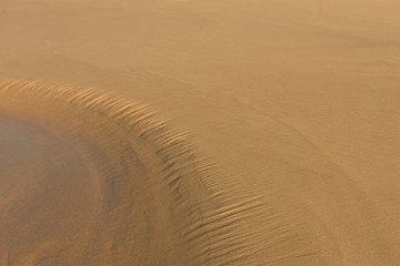Curved water flow natural sand texture background