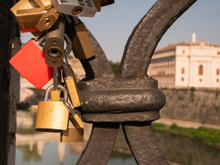 locks hanging on the bridge near Castel Sant Angelo in Rome