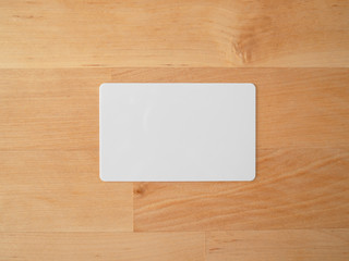 Empty mockup card on wooden table.