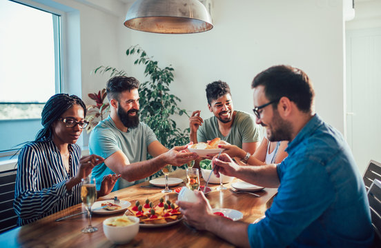 Group of multiethnic friends enjoying dinner party