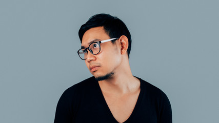 Man with boring and ignoring face on isolated blue background.