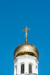 Golden cross on bell tower dome