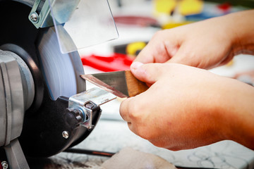 Sharpening the metal cutter on the grinding machine