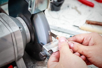 Sharpening the metal cutter on the grinding machine