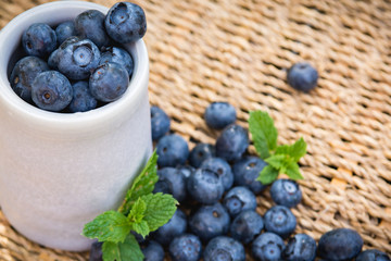 Blueberries. Freshly picked blueberry in ceramic bowl with berries and natural background. Blueberries are known to contain anitoxidant for nutrition health benefits