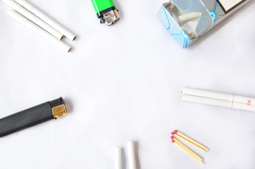 Cigarettes and items on a white background, with a bundle and a cigarette lighter, a box