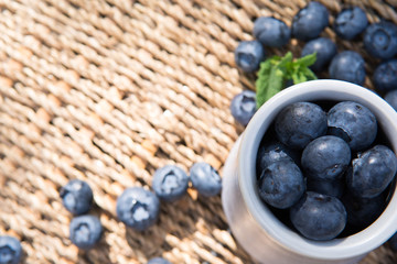 Blueberries. Freshly picked blueberry in ceramic bowl with berries and natural background. Blueberries are known to contain anitoxidant for nutrition health benefits