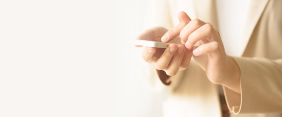 Businesswomen hand using smartphone on blur abstract background with copy space. Banner. Business,...