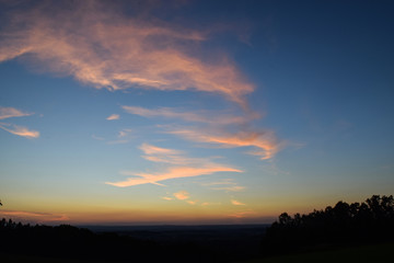 Fototapeta na wymiar Sky during a sunset illuminating meadow below
