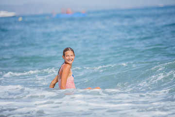 Girl in swimsuit having fun on tropical beach