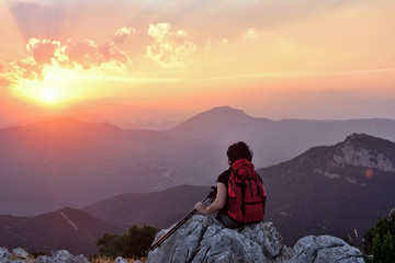 Fototapeta premium .female hiker resting and watching the sunset