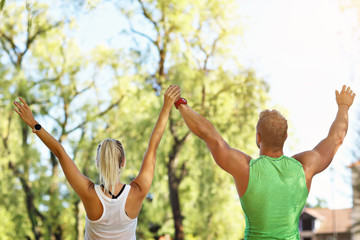 Obraz premium Young couple working out in park