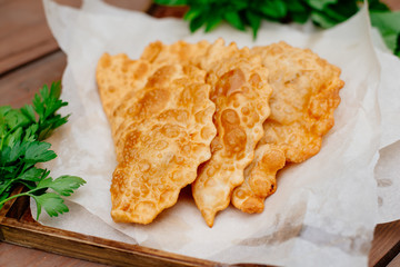 The Caucasian food is a patty made from thin unleavened dough with stuffed lamb and spicy seasonings. Cheburek - fried pie with meat and onions. Traditional dish of many tatar and eastern peoples.