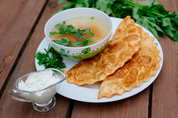 The Caucasian food is a patty made from thin unleavened dough with stuffed lamb and spicy seasonings. Cheburek - fried pie with meat and onions. Traditional dish of many tatar and eastern peoples.