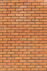 Red brick wall. Decorative brick with artificial defects and cracks. Vertical view