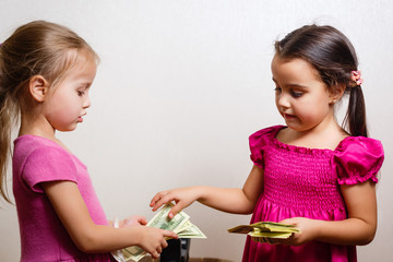 Two girls counting their money