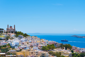 Obraz premium Panoramic view of Ermoupoli city of Syros Island in Cyclades, Greece. Top view of the colorful houses, the port and the Orthodox Anastaseos church