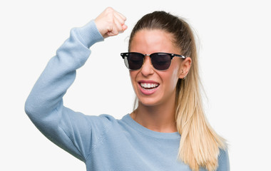 Beautiful young woman wearing sunglasses and ponytail annoyed and frustrated shouting with anger, crazy and yelling with raised hand, anger concept