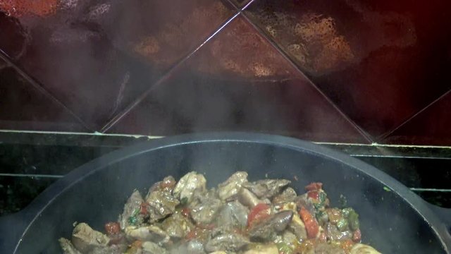 4k, Chef cooking red and green peppers with chicken hearts and livers in a frying pan. Roasting stewpan with tasty and healthy vegetables and chicken liver. Delicious nutritious organic dietary -Dan