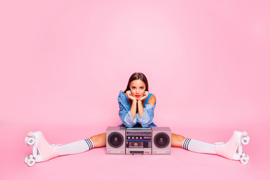 Full-size photo of excited beautiful lovely girl sitting on twine in rollers with a boombox isolated on pink vivid background