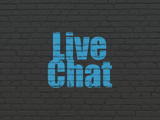 Web development concept: Painted blue text Live Chat on Black Brick wall background