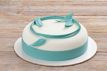 white mousse cake on wooden background 