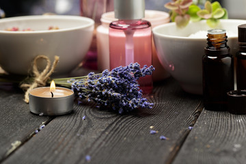 Aromatic composition of lavender, herbs, cosmetics and salt on a dark table top