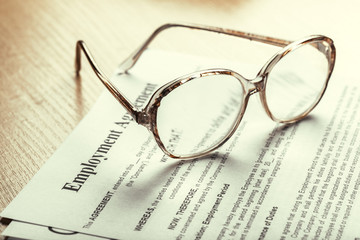 Close up shot of Eyeglasses  on contract document papers business concept
