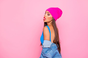 Obraz na płótnie Canvas Side profile view photo portrait of attractive confident charming gorgeous lady showing tongue looking down isolated bright vivid pastel background