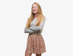 Blonde teenager woman wearing flowers skirt happy face smiling with crossed arms looking at the camera. Positive person.